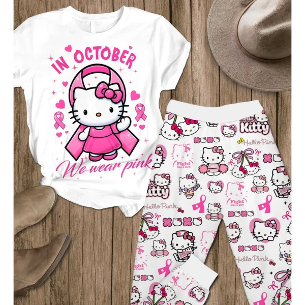 The full Hello Kitty "In October We Wear Pink" pajama set, including t-shirt and pants, laid flat on a wooden background.