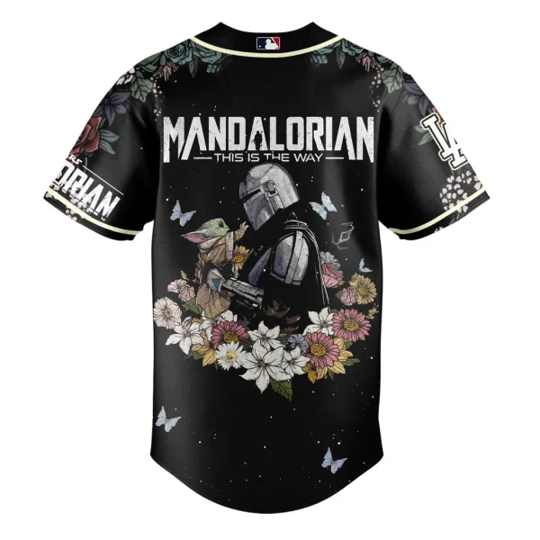 Back of the Star Wars Mandalorian baseball jersey showing the Mandalorian holding Grogu amidst flowers with "THIS IS THE WAY" text.