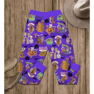 A detailed view of the purple Scooby-Doo Halloween pajama pants with an all-over print of characters, pumpkins, and spooky phrases.