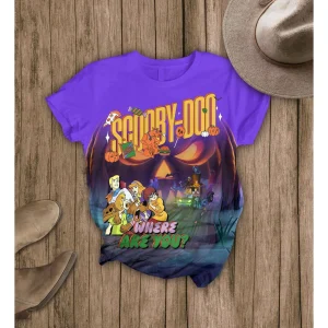 The purple Scooby-Doo Halloween graphic t-shirt from the pajama set, shown flat on a wooden surface with boots and a hat.