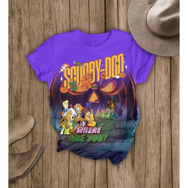 The purple Scooby-Doo Halloween graphic t-shirt from the pajama set, shown flat on a wooden surface with boots and a hat.