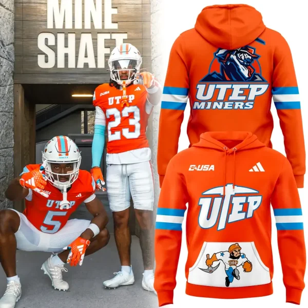 Two UTEP Miners football players in orange throwback jerseys pose next to the matching orange limited edition throwback hoodie.