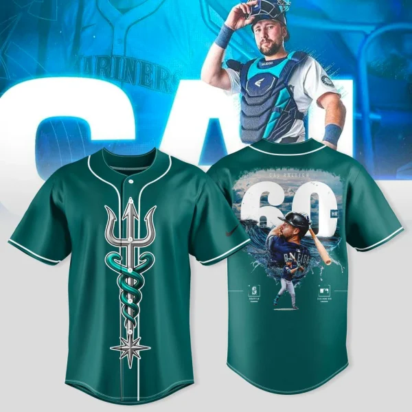 Front view of teal Seattle Mariners jersey featuring a stylized trident-and-compass graphic down the center, white piping on the collar and sleeves, and a team patch on the left sleeve.