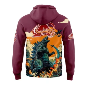 Back view of the maroon hoodie showing Godzilla roaring up at jets, with a large Colorado Avalanche logo above the city destruction scene.