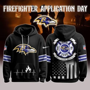 Front and back views of a black Baltimore Ravens firefighter hoodie showing the Ravens logo on the chest, heartbeat flame graphic at the pocket, purple sleeve stripes and a firefighter department crest over a monochrome American flag on the back.