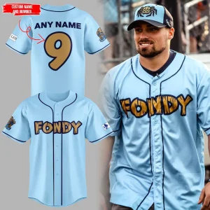 Man wearing a light blue Fondy baseball jersey. Inset images show the front and customizable back of the Dock Spiders jersey.