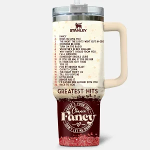 Back of the Reba McEntire tumbler displaying a list of her greatest hits and lyrics from her song 'Fancy'.