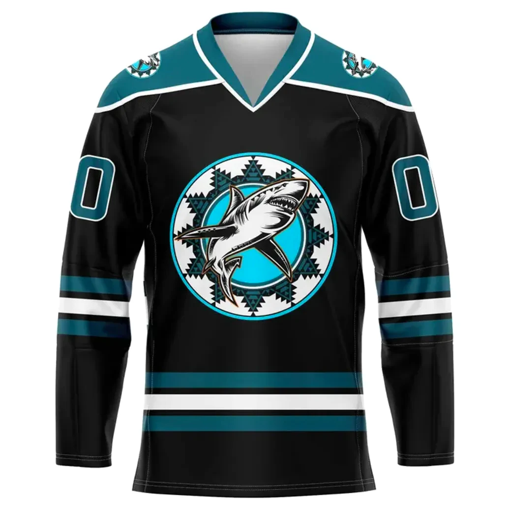 Front View — San Jose Sharks 2025 Heritage Jersey Front view of black jersey featuring central Native American–inspired circular shark logo in teal and white, teal shoulder patches, V-neck collar, and matching teal and white stripes on sleeves and hem.
