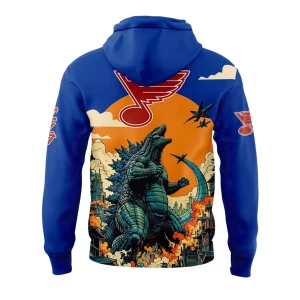 Back of the St Louis Blues hoodie showing Godzilla roaring at jets, with the large Blues musical note logo set against an orange sun.